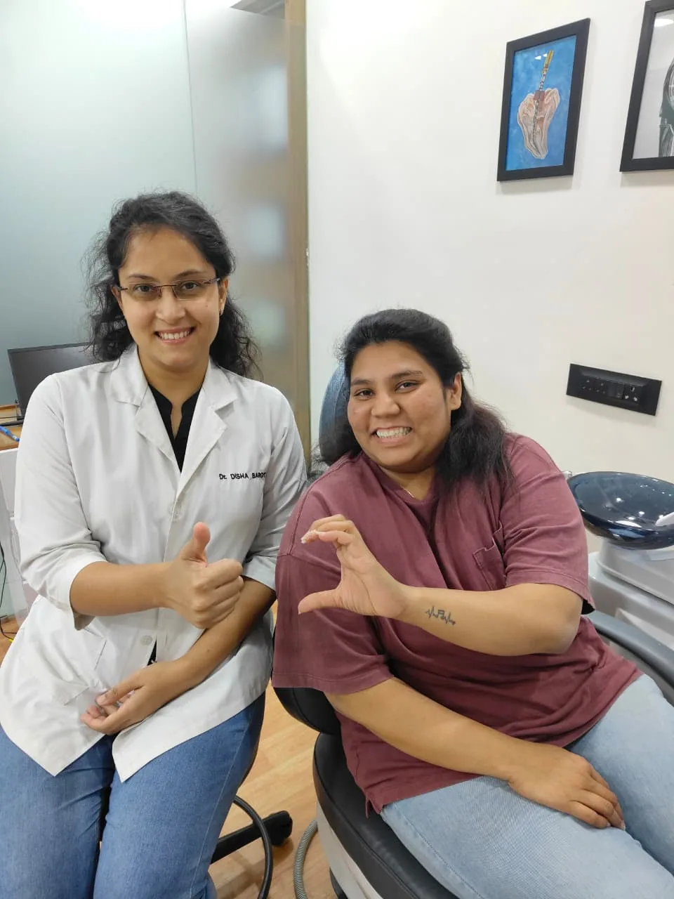 Dr. Disha Barot with a patient holding her clear aligner