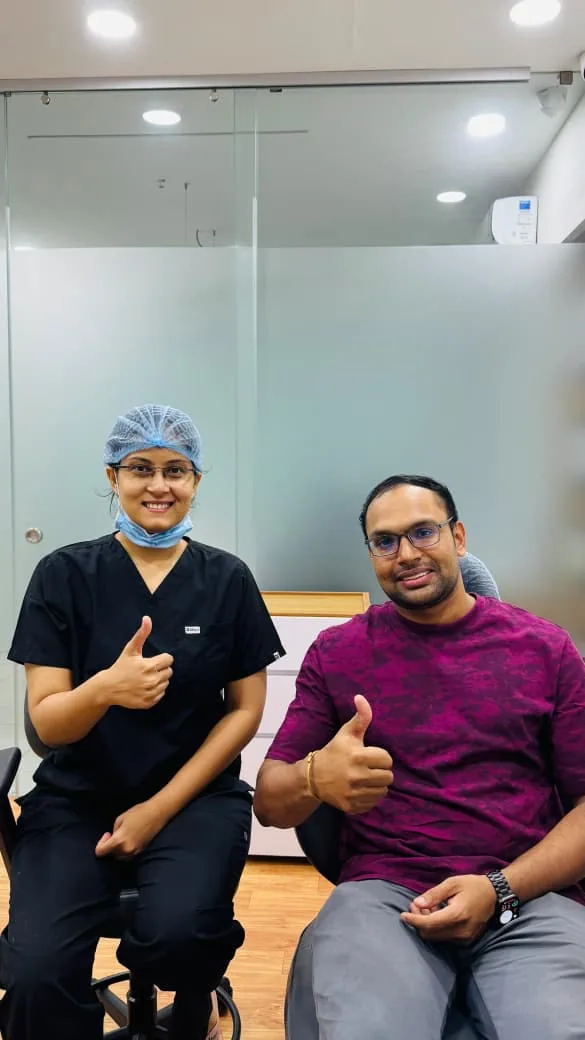 Dr. Disha Barot with a Disharth Dentistry patient
